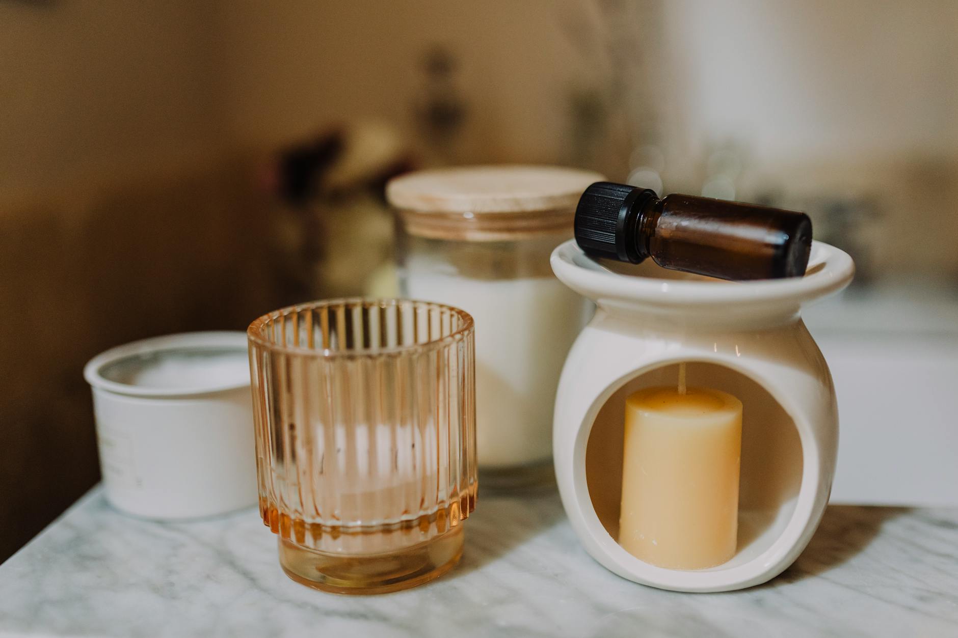 Podgrzewacz do olejków: jak uzyskać temperaturę jak w spa, bez ryzyka oparzeń Aromaterapia w stylu spa z olejkami i świecami na marmurowym blacie